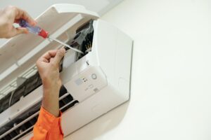 Technician Installing Air Conditioner